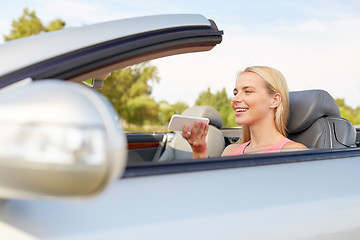 Image showing woman recording voice on smartphone at car