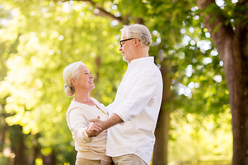 Image showing happy senior couple dancing at summer park