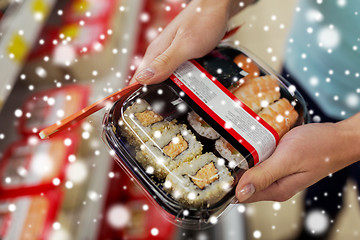 Image showing hands with sushi pack at grocery or supermarket