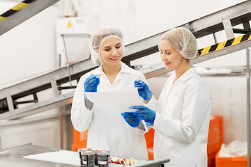 Image showing women technologists tasting ice cream at factory