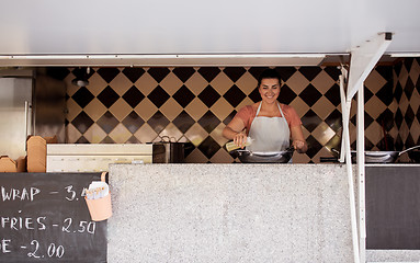 Image showing happy chef or seller cooking at food truck