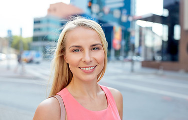 Image showing happy smiling young woman on city street