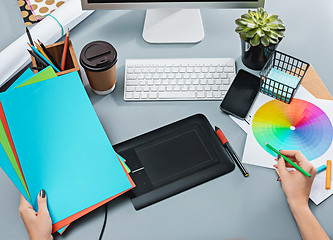 Image showing The gray desk with laptop, notepad with blank sheet, pot of flower, stylus and tablet for retouching