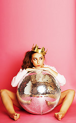 Image showing young cute disco girl on pink background with disco ball and cro