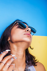 Image showing lifestyle people concept. young pretty smiling indian girl with long nails wearing lot of jewelry rings, asian summer happy cool