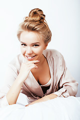 Image showing young pretty woman happy smiling, laying in bed, lifestyle people concept