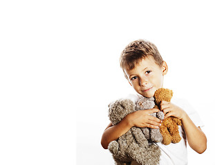 Image showing little cute boy with many teddy bears hugging isolated close up