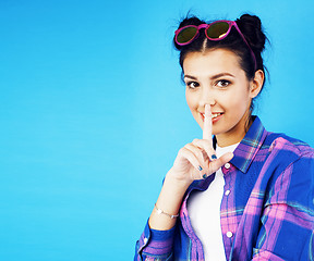 Image showing young pretty woman fooling around on blue background close up smiling, lifestyle people concept
