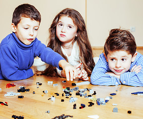 Image showing funny cute children playing toys at home, boys and girl smiling, first education role close up, lifestyle people concept