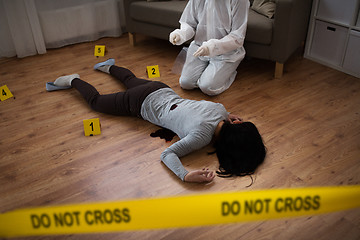 Image showing criminalist collecting evidence at crime scene