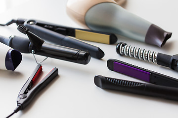 Image showing hot styling and curling irons with hairdryers