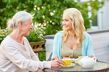 Image showing daughter with senior mother drinking tea at cafe