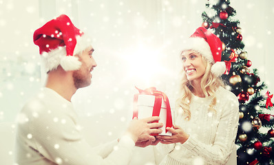 Image showing happy couple at home with christmas gift box