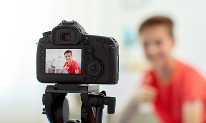 Image showing camera recording video of blogger boy at home