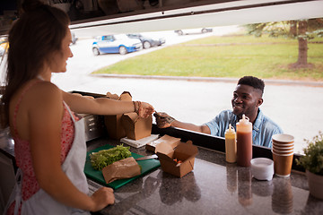 Image showing african american man buying wok at food truck