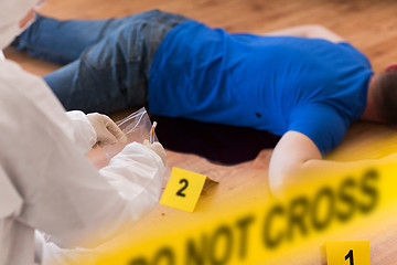 Image showing criminalist collecting evidence at crime scene