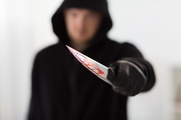 Image showing close up of criminal with blood on knife