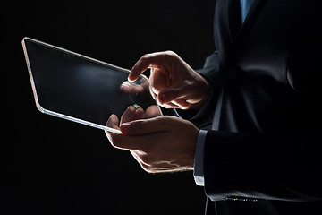 Image showing close up of businessman with transparent tablet pc