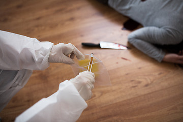 Image showing criminalist collecting crime scene evidence