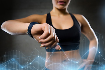 Image showing woman with heart-rate watch in gym