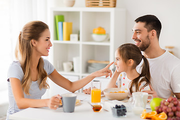 Image showing happy family having breakfast at home