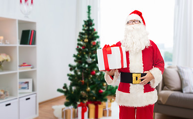 Image showing santa claus with christmas gift at home