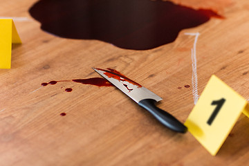 Image showing knife in blood and chalk outline at crime scene