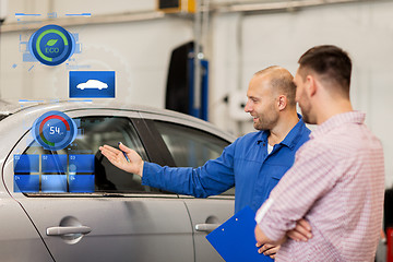 Image showing auto mechanic with clipboard and man at car shop