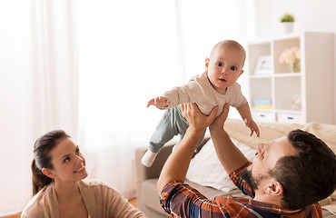 Image showing happy mother and father playing with baby at home