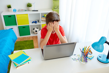 Image showing upset student boy with laptop computer at home