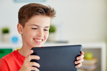 Image showing close up of boy with tablet pc computer at home