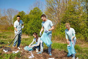 Image showing volunteers with garbage bags cleaning park area