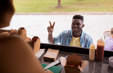 Image showing african american man ordering wok at food truck