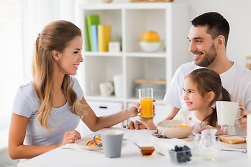 Image showing happy family having breakfast at home