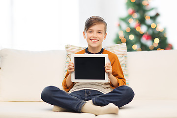 Image showing smiling boy with tablet pc at home at christmas