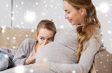 Image showing pregnant woman and girl talking to baby in belly