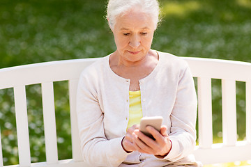 Image showing senior woman with smartphone at summer park