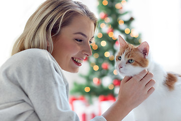 Image showing happy young woman with cat at christmas