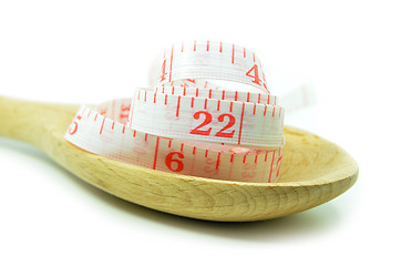 Image showing White measurement tape with wooden spoon