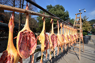 Image showing Rows of cured meat hanging to dry
