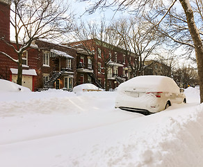 Image showing Urban winter street with cars stuck in snow