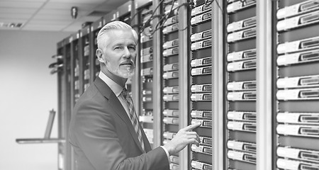 Image showing Senior businessman in server room