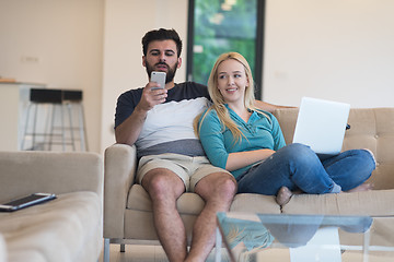 Image showing young happy couple relaxes in the living room