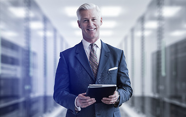 Image showing Senior businessman in server room