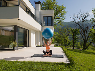 Image showing woman doing exercise with pilates ball