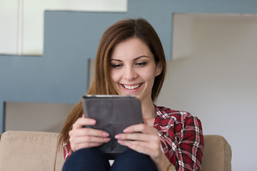 Image showing woman sitting on sofa with tablet computer