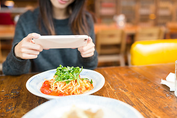 Image showing Woman taking photo on her dish and posting on social network 