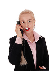 Image showing Business woman talking on an old phone