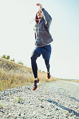 Image showing Running sport. Man runner sprinting outdoor in scenic nature. Fit muscular male athlete training trail running for marathon run.