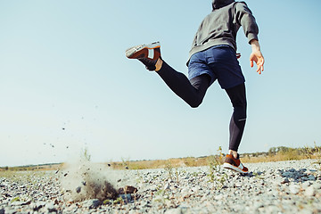 Image showing Running sport. Man runner sprinting outdoor in scenic nature. Fit muscular male athlete training trail running for marathon run.